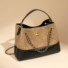 Top view of two-tone woven-look shoulder bag and chain detail