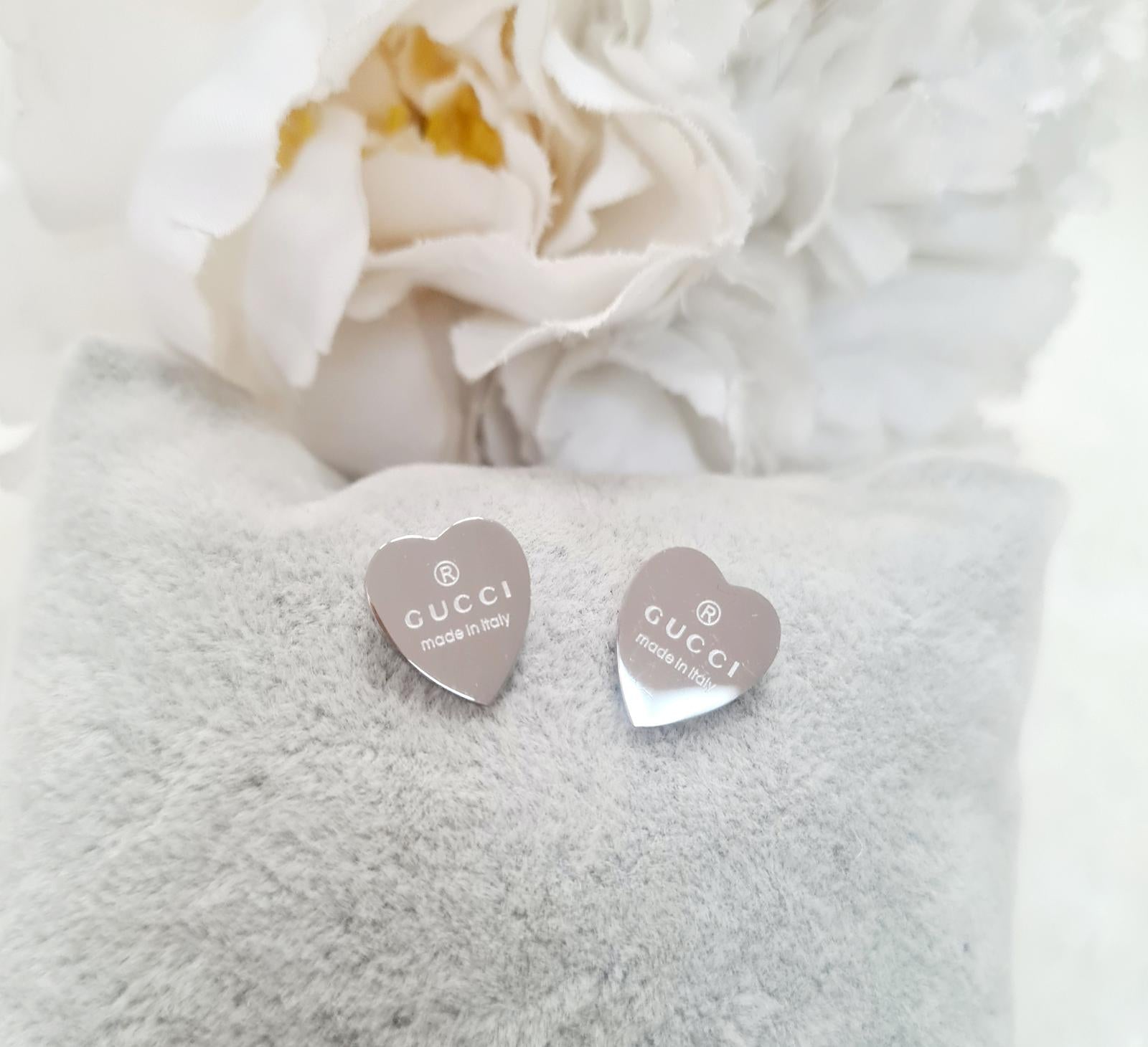 Gold heart earrings with a classic designer touch.