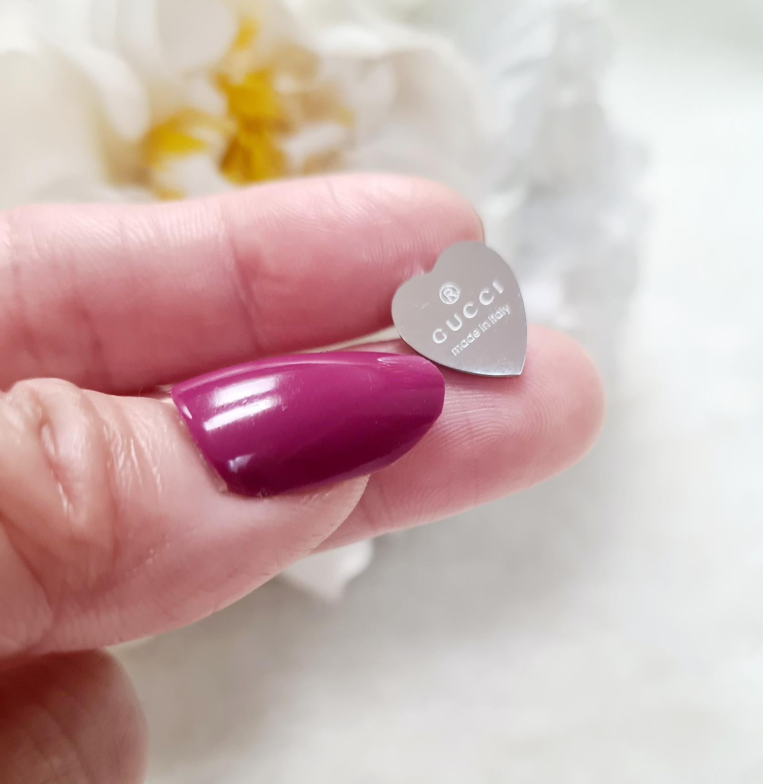 Gold heart earrings with a classic designer touch.